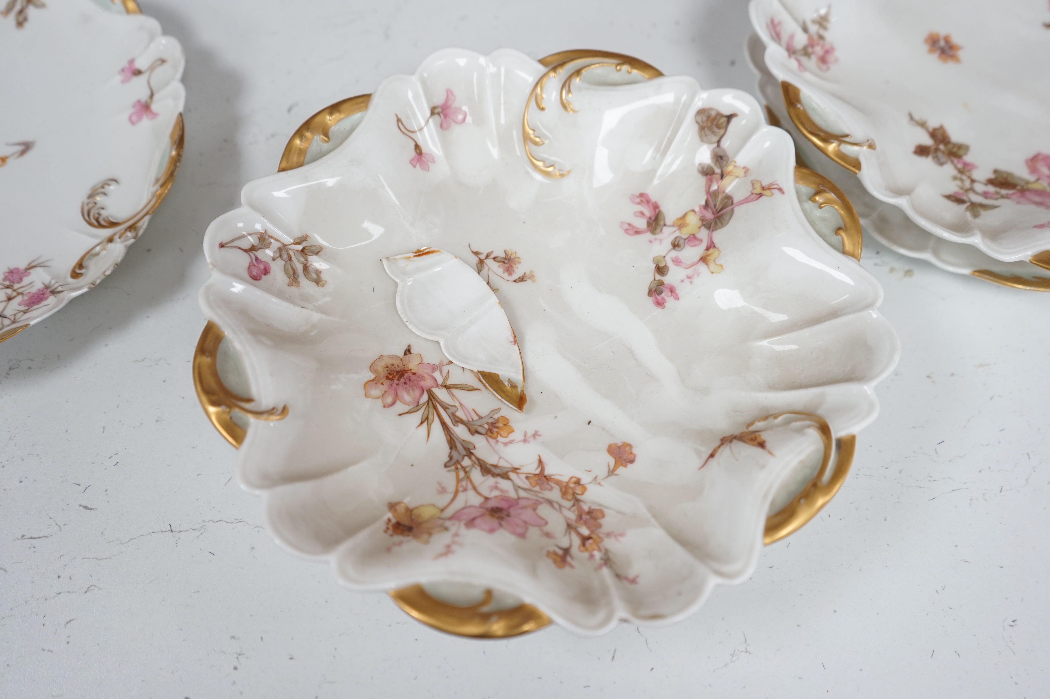 A Limoges eight piece dessert service with gilt decoration, 26cm wide